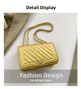 Detail of yellow chevron quilted crossbody bag with gold chain strap and twist lock
