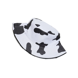 Detail of high-density canvas bucket hat with classic black and white cow print texture