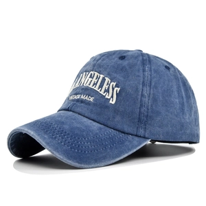 Detail of white 3D embroidery on washed cotton navy blue vintage baseball cap