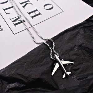 Hip hop silver airplane pendant necklace for men and women on a stylish black background