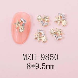 Detailed view of 3D gold alloy starfish nail charms with rhinestones on pink nails