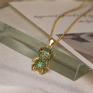 Gold plated teddy bear necklace featuring micro-set green zircons on a delicate O-chain