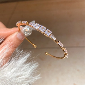 18K gold-plated open cuff bracelet with sparkling square-cut cubic zirconia crystals