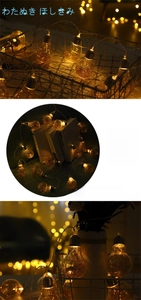 Close-up of vintage warm LED fairy lights inside glass bulbs for festive home decoration