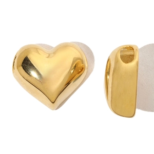 Detailed macro of gold-plated heart pendant with embedded colorful crystals and DIY hole