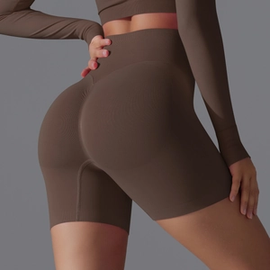 Close-up of high-waist seamless yoga shorts in coffee brown with peach butt lift detail