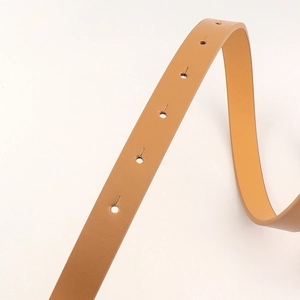 Close-up of brown PU leather belt showing fine lychee texture and neat adjustment holes