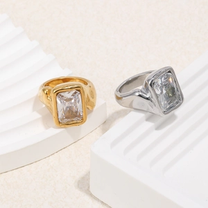 Detail of square-cut crystals and hammered texture on 18K gold and silver rings