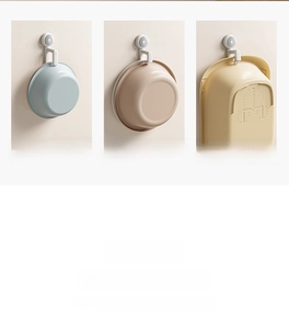 Space-saving wall mounted hook holding blue, brown, and yellow basins in a bathroom