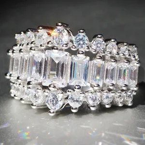 Sparkling silver-tone wedding ring featuring large emerald-cut and round cubic zirconia