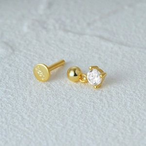 Macro shot of S925 sterling silver flat back stud earrings with sparkling clear gemstones