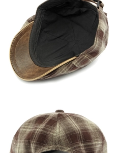 Detalle de gorra de cuadros con visera de cuero sintético y forro con etiqueta