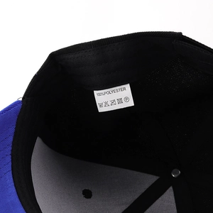 Detail shot of 100% polyester baseball cap interior showing washing label and blue brim