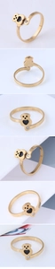 Detailed views of gold bear ring featuring black heart center and zircon stone