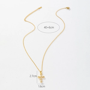 Detail view of gold cross pendant necklace showing 2.7cm by 1.6cm dimensions on white background