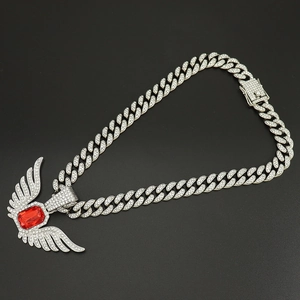 Macro shot of silver hip hop necklace with ruby angel wing pendant and pavé stones