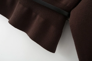 Macro shot of dark coffee brown ribbed knit cuffs and high-quality fabric texture