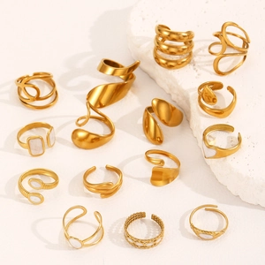 Collection of gold plated stainless steel rings with white enamel on stone blocks