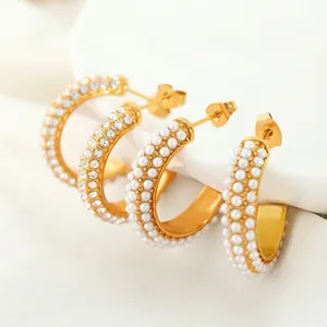 Elegant gold plated C-shaped hoop earrings with rows of white pearls and sparkling crystals