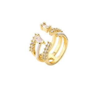 Gold triple-layer open ring with white enamel and sparkling zircon stones on white background