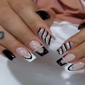 Handmade long square press-on nails featuring black and white French tips with silver swirls