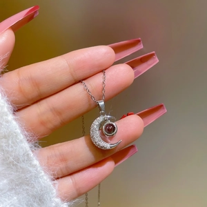 Silver-toned crescent moon necklace with I Love You projection stone on a fine chain