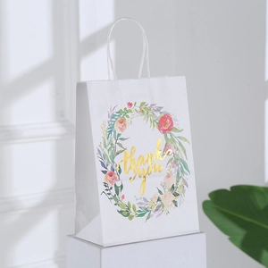 White kraft paper gift bag with floral wreath and gold foil Thank You lettering
