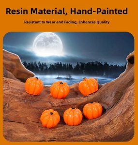 Detailed macro view of six miniature resin pumpkins with polished orange finish