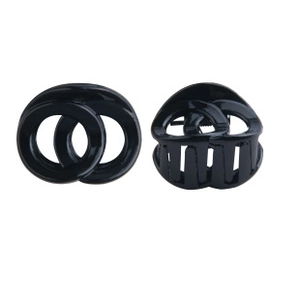 Detail of black glossy resin hair clips with interlocking circles in pairs