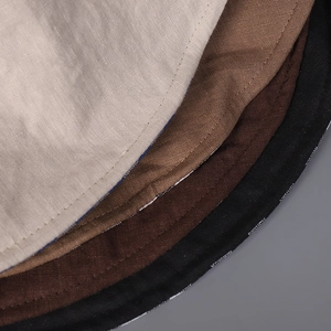 Detail of linen sun hat stitching showing multi-color fabric layers and fine woven texture