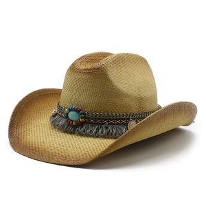 Ethnic western straw cowboy hat with turquoise stone and fringe on white background