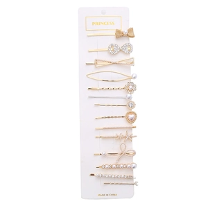 14-piece gold hair clip set with white pearls and rhinestones on display card