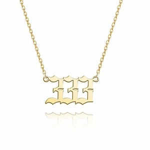Macro shot of 14K gold-plated Gothic number 111 pendant on a delicate link chain necklace