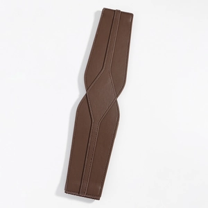 Detailed view of the brown PU leather wide belt featuring fine litchi texture and stitching