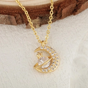 Gold moon and planet pendant necklace with shimmering cubic zirconia and star detail