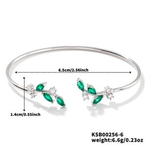 Detail view of silver willow leaf bracelet with green gems and 6.5cm inner diameter