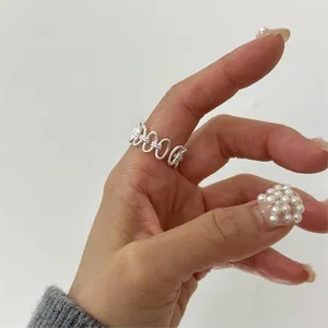 Macro view of S925 sterling silver twisted woven hollow ring on finger