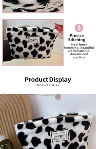 Close-up of fluffy cow print plush pouch with heart pattern and zipper detail
