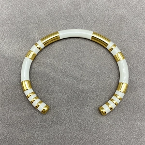 Modern gold and white enamel striped open bangle bracelet for a layered jewelry look