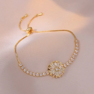 Detail of sunflower charm bracelet with marquise zircon petals on champagne silk cloth