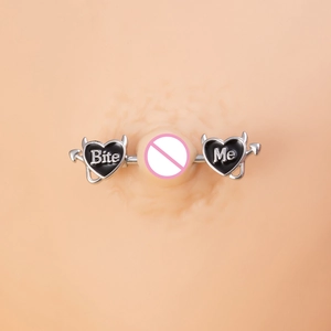 Macro detail of devil heart nipple ring with Bite Me letters and black oil drip finish