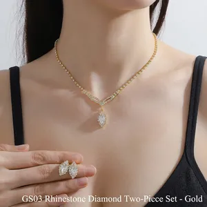 Detail of elegant gold rhinestone zircon necklace and earrings set worn by a model