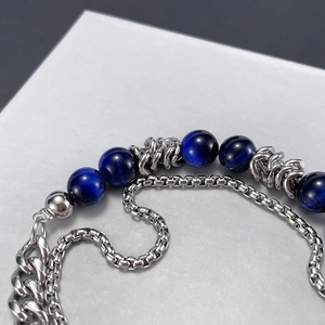 Close-up of double-layer stainless steel bracelet with dark blue tiger eye stones