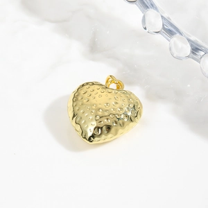 Detailed view of 18k gold plated hollow heart pendant with hammered metal texture