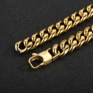 Detailed close-up of golden stainless steel Cuban link chain with a secure buckle