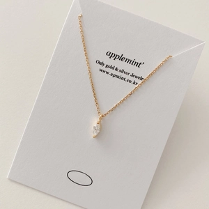 Close-up of gold S925 sterling silver necklace with marquise-cut zircon on display card