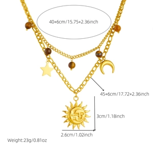 Vintage gold layered necklace with sun and moon pendants featuring tiger eye beads detail