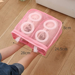 Pink mesh laundry bag for shoes showing dimensions 28cm x 24.5cm x 8cm on wood floor
