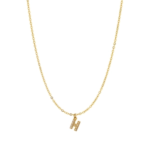 Macro shot of gold pendant featuring micro-paved white zircons on letter H charm
