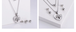 Detailed set of hollow heart tree of life necklace and sphere studs in steel finish